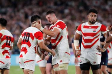 Japan celebrate after beating Scotland to progress to their first-ever Rugby World Cup Quarter-Final.