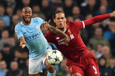 Raheem Sterling of Manchester City and Virgil van Dijk of Liverpool tussle for possession